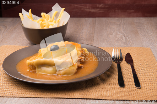 Image of Francesinha and french fries