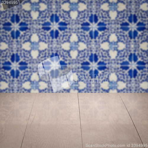 Image of Wood table top and blur vintage ceramic tile pattern wall