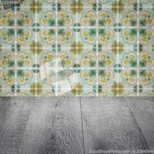 Image of Wood table top and blur vintage ceramic tile pattern wall
