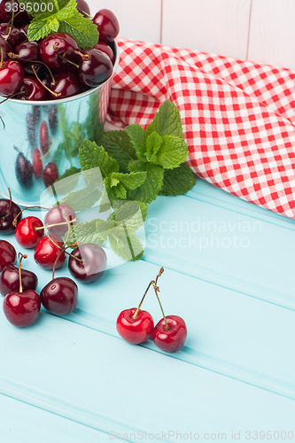 Image of Cherries in blue wooden table