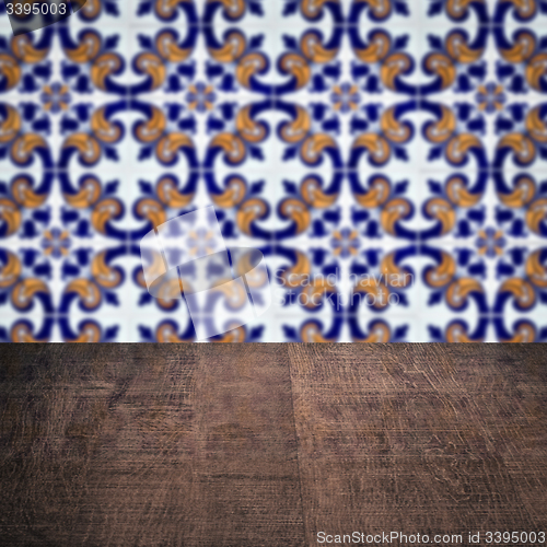 Image of Wood table top and blur vintage ceramic tile pattern wall
