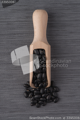 Image of Wooden scoop with black beans