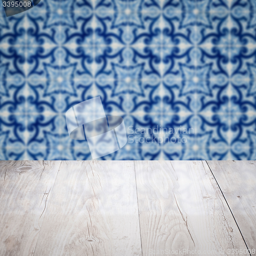 Image of Wood table top and blur vintage ceramic tile pattern wall