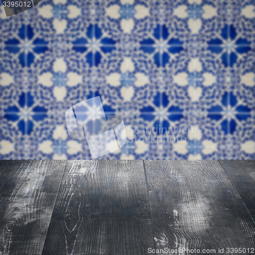 Image of Wood table top and blur vintage ceramic tile pattern wall