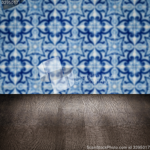 Image of Wood table top and blur vintage ceramic tile pattern wall