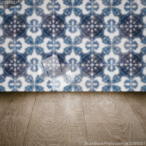 Image of Wood table top and blur vintage ceramic tile pattern wall