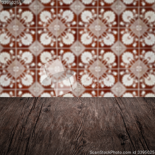 Image of Wood table top and blur vintage ceramic tile pattern wall