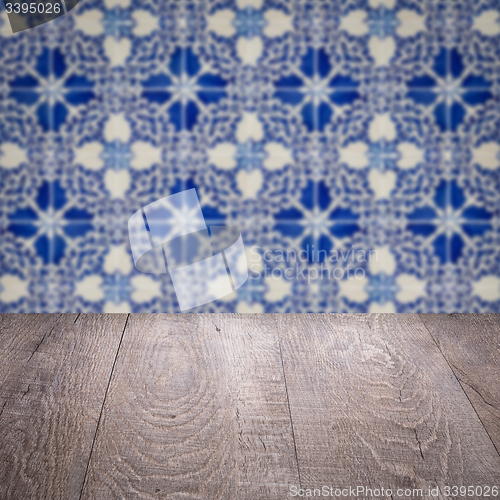 Image of Wood table top and blur vintage ceramic tile pattern wall