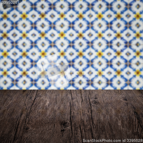 Image of Wood table top and blur vintage ceramic tile pattern wall