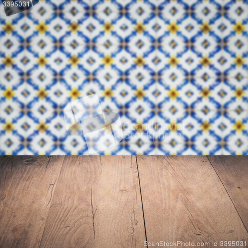 Image of Wood table top and blur vintage ceramic tile pattern wall