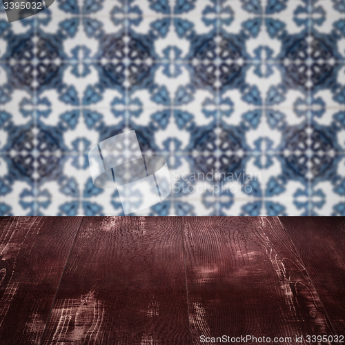 Image of Wood table top and blur vintage ceramic tile pattern wall