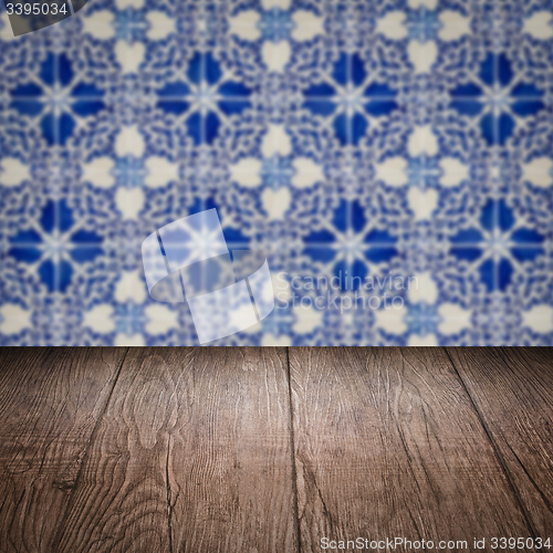 Image of Wood table top and blur vintage ceramic tile pattern wall