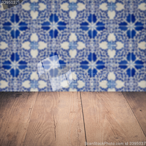 Image of Wood table top and blur vintage ceramic tile pattern wall