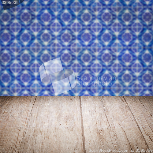 Image of Wood table top and blur vintage ceramic tile pattern wall