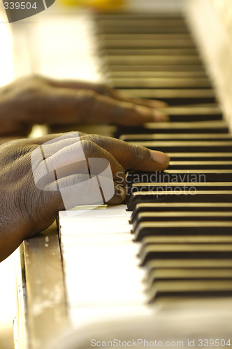 Image of Hands and old piano