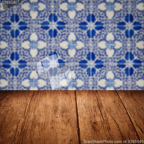 Image of Wood table top and blur vintage ceramic tile pattern wall