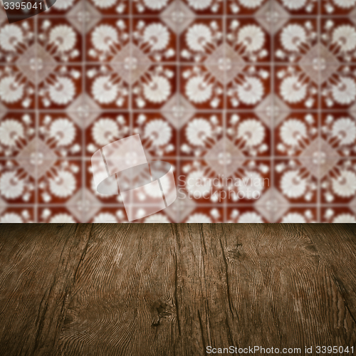 Image of Wood table top and blur vintage ceramic tile pattern wall