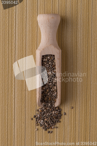 Image of Wooden scoop with chia seeds