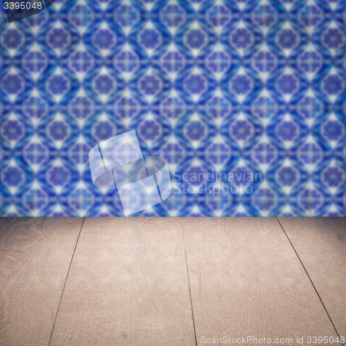 Image of Wood table top and blur vintage ceramic tile pattern wall