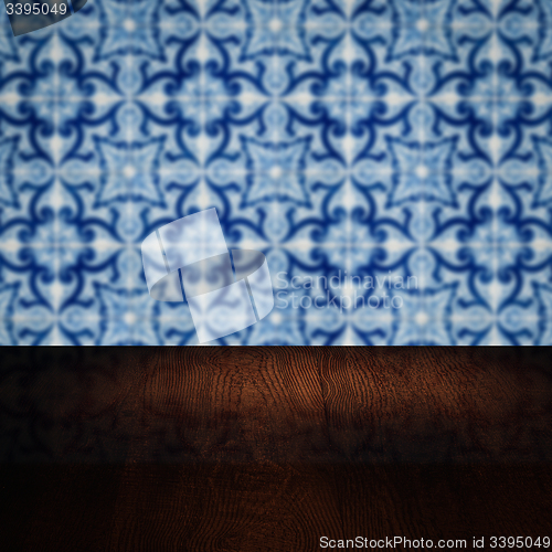 Image of Wood table top and blur vintage ceramic tile pattern wall