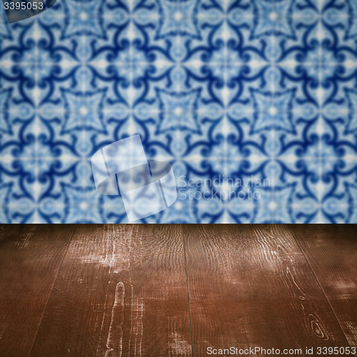 Image of Wood table top and blur vintage ceramic tile pattern wall