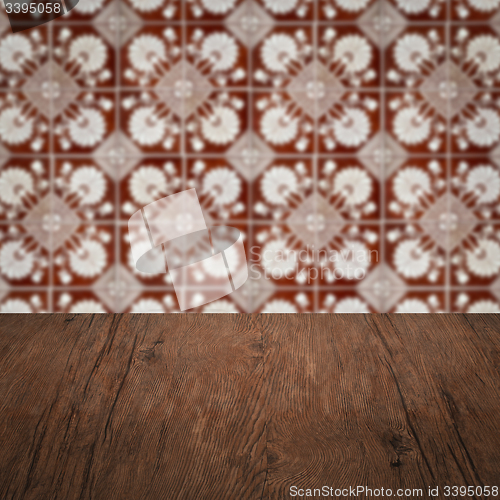 Image of Wood table top and blur vintage ceramic tile pattern wall