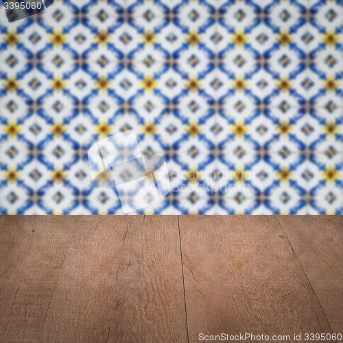 Image of Wood table top and blur vintage ceramic tile pattern wall