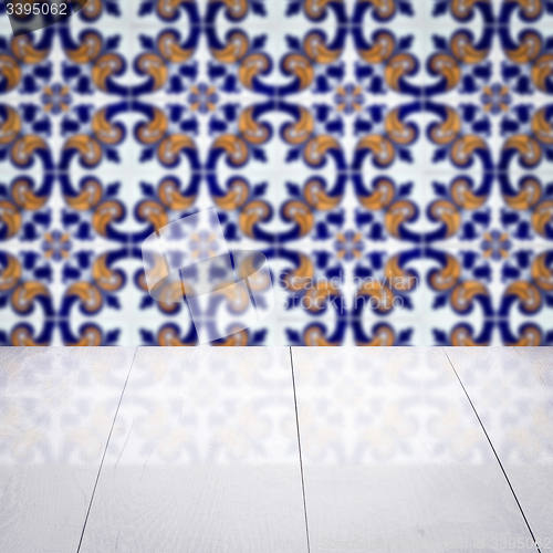 Image of Wood table top and blur vintage ceramic tile pattern wall