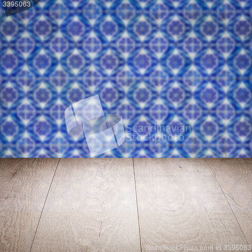 Image of Wood table top and blur vintage ceramic tile pattern wall