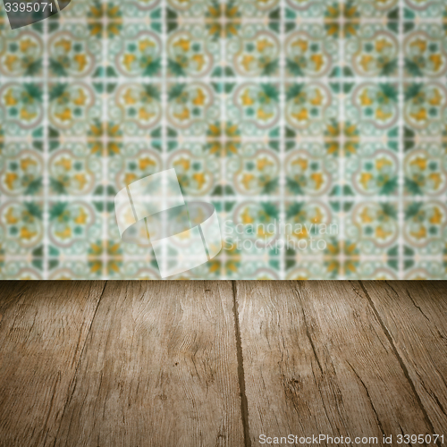 Image of Wood table top and blur vintage ceramic tile pattern wall