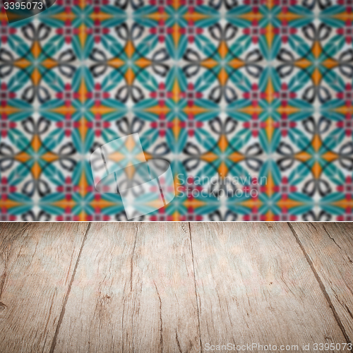 Image of Wood table top and blur vintage ceramic tile pattern wall