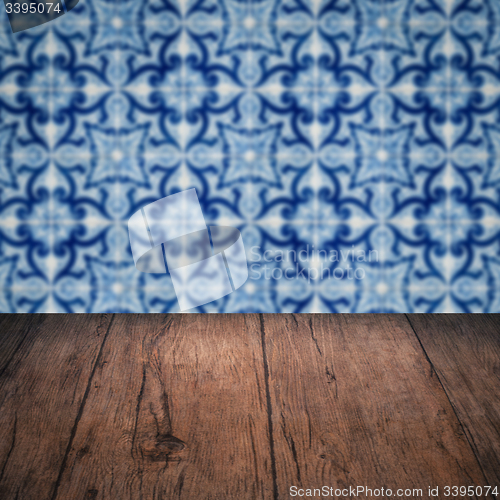 Image of Wood table top and blur vintage ceramic tile pattern wall