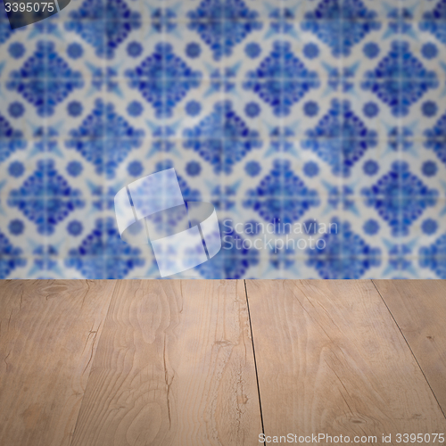 Image of Wood table top and blur vintage ceramic tile pattern wall