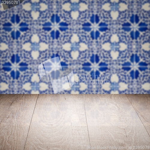 Image of Wood table top and blur vintage ceramic tile pattern wall