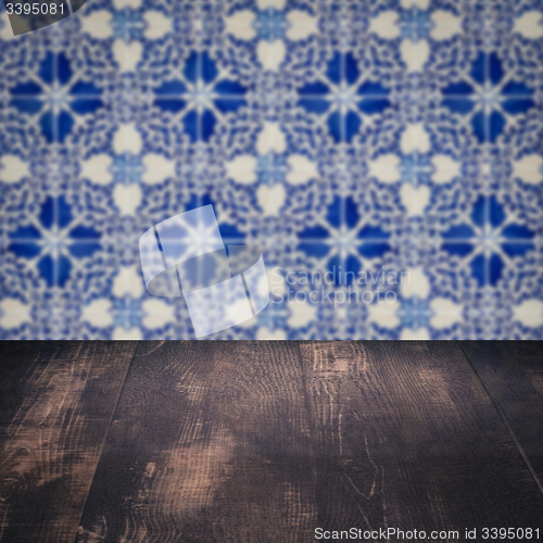 Image of Wood table top and blur vintage ceramic tile pattern wall