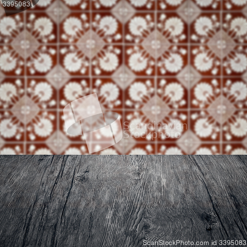 Image of Wood table top and blur vintage ceramic tile pattern wall