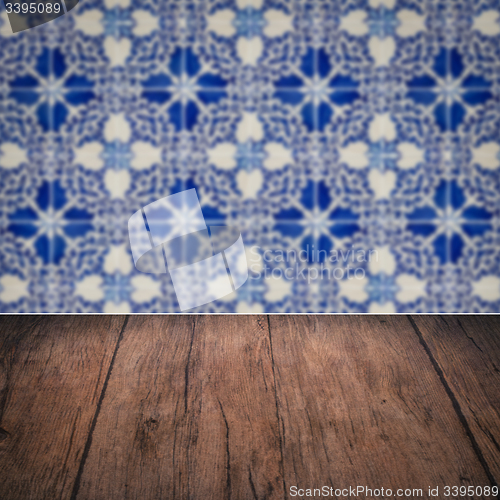 Image of Wood table top and blur vintage ceramic tile pattern wall
