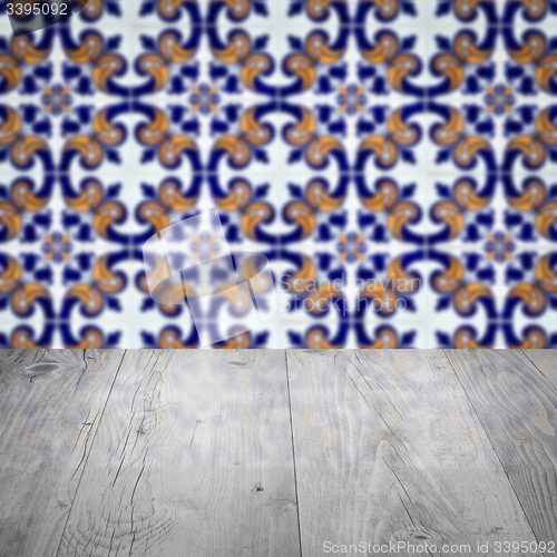 Image of Wood table top and blur vintage ceramic tile pattern wall