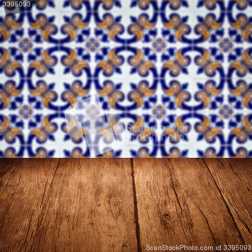 Image of Wood table top and blur vintage ceramic tile pattern wall