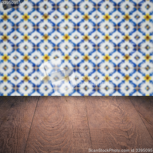 Image of Wood table top and blur vintage ceramic tile pattern wall