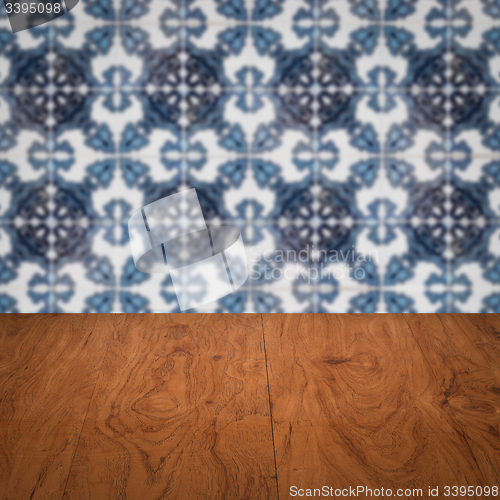 Image of Wood table top and blur vintage ceramic tile pattern wall