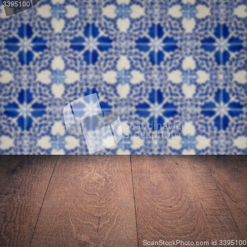 Image of Wood table top and blur vintage ceramic tile pattern wall