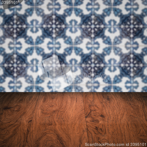 Image of Wood table top and blur vintage ceramic tile pattern wall