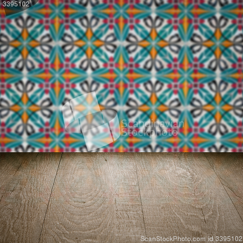 Image of Wood table top and blur vintage ceramic tile pattern wall