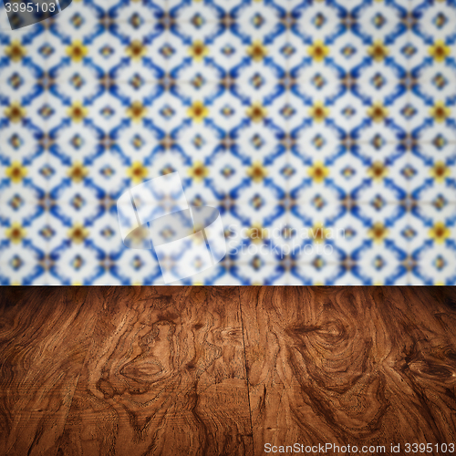 Image of Wood table top and blur vintage ceramic tile pattern wall