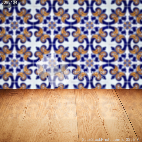 Image of Wood table top and blur vintage ceramic tile pattern wall