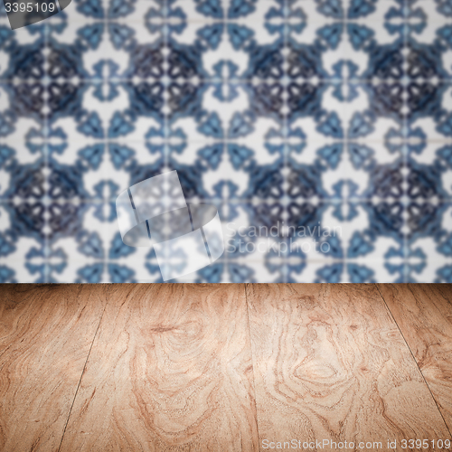 Image of Wood table top and blur vintage ceramic tile pattern wall