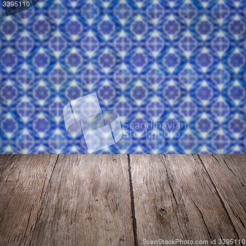 Image of Wood table top and blur vintage ceramic tile pattern wall