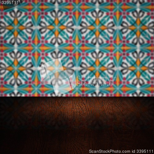 Image of Wood table top and blur vintage ceramic tile pattern wall