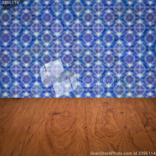 Image of Wood table top and blur vintage ceramic tile pattern wall